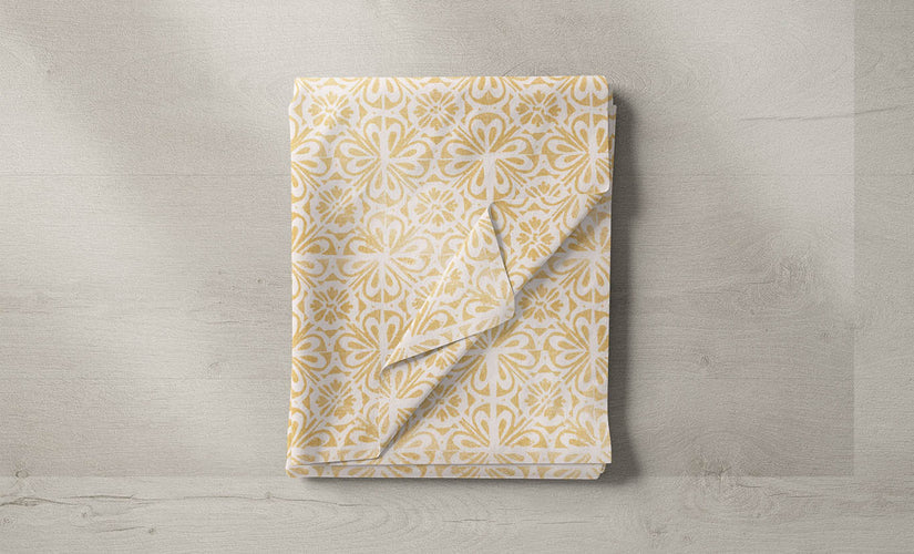 Assorted yellow and gold fabrics in various patterns and textures, ideal for adding warmth and elegance to home interiors