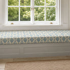 Agadir Aegean geometric upholstery fabric shown on a window bench, blue Mediterranean fabric for seating and cushions