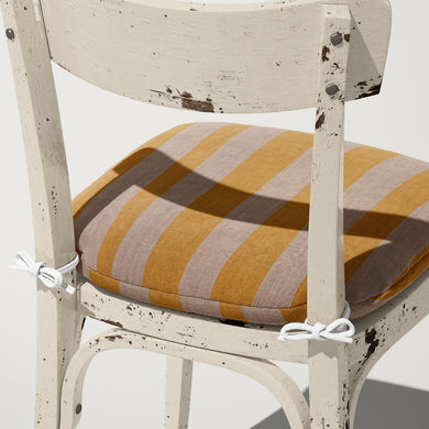 Altena Ochre upholstery fabric on cushion – golden yellow stripe on textured neutral base