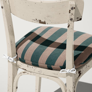 Cushion upholstered in Altena Teal fabric – teal stripe adds colour to neutral upholstery setting