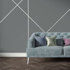 Blue velvet sofa upholstered in Archway Azure upholstery fabric with bold Art Deco arches in white