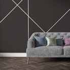 Grey velvet sofa upholstered in Archway Grey upholstery fabric featuring graphic arch shapes for a modern look