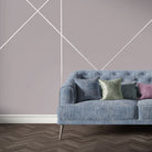 Dark blue velvet sofa upholstered in Archway Ink upholstery fabric with Art Deco style geometric arch pattern