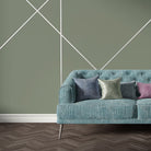 Soft green velvet sofa upholstered in Archway Jade upholstery fabric with geometric arch repeat pattern