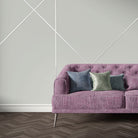 Purple velvet sofa upholstered in Archway Mauve upholstery fabric with bold striped arch motif