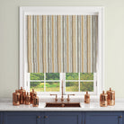 Ochre and grey striped curtain fabric styled as a Roman blind