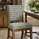 Azrou Aegean blue upholstery fabric on a dining chair, geometric Mediterranean print for statement seating