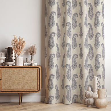 Baku Paisley Linen curtain fabric in navy blue, styled as elegant draped curtains in a sophisticated interior.