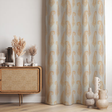 Baku Paisley Linen curtain fabric in ochre yellow, styled as elegant draped curtains in a warm-toned interior