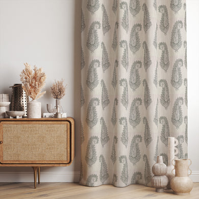 aku Paisley Linen curtain fabric in sage green, styled as elegant draped curtains in a modern interior.
