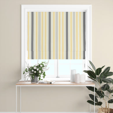 Boston Stripe Ochre Cotton Curtain Fabric styled as a Roman blind with bold yellow and grey stripes, perfect for contemporary spaces.