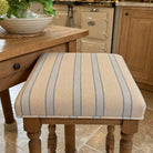 Braemar Blue striped upholstery fabric shown on a stool, durable 35,000 Martindale fabric for chair upholstery and soft furnishings