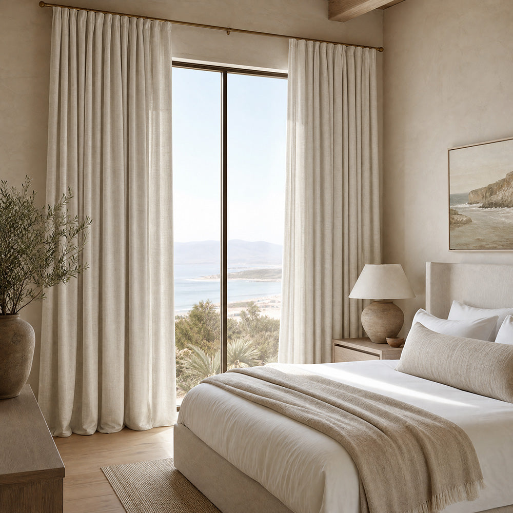 Ivory Broadway Plain Linen Fabric curtains in contemporary neutral bedroom with floor-to-ceiling window, soft drape and elegant coastal-inspired styling.