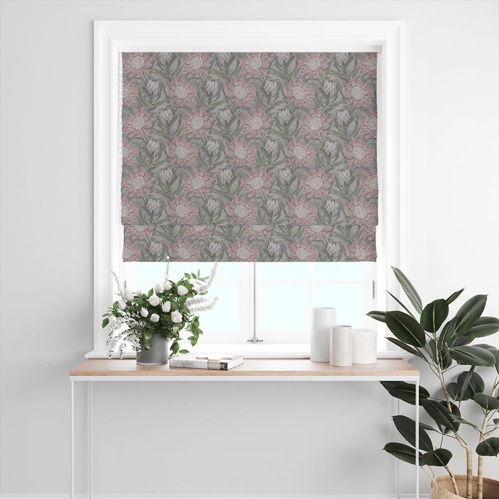 Calstock Dusk floral linen curtain fabric shown as a Roman blind with vintage-style flowers in muted mauve and grey on a natural-toned background