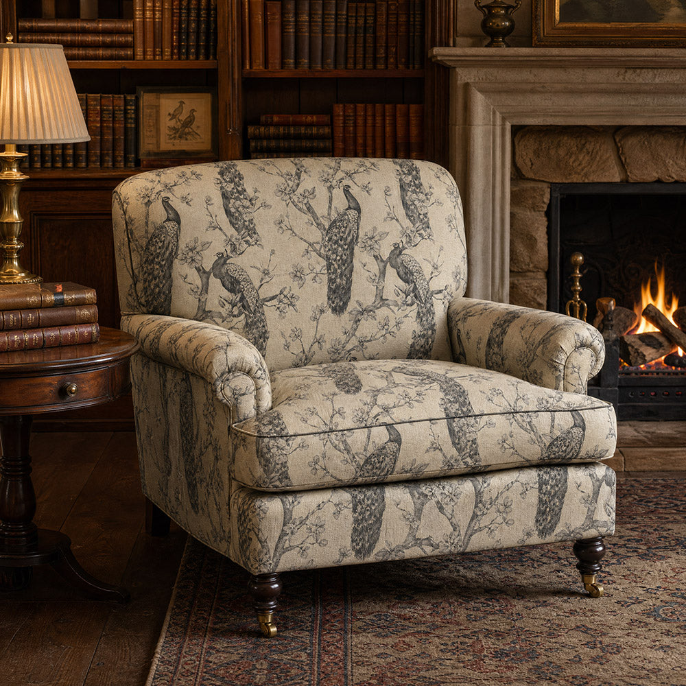 Chinoise Peacock Monochrome upholstery fabric shown on an armchair, bold black and white bird print fabric for statement seating