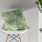 Colmar green bird and floral toile fabric shown on a tailored scatter cushion