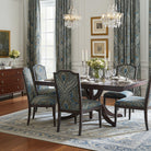 Teal peacock patterned curtain fabric in an elegant dining room with matching chairs and crystal chandeliers