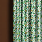 Ennerdale leaf fabric shown as green patterned curtains for a fresh nature-inspired room