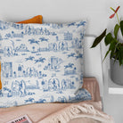 Blue and white equestrian curtain fabric styled as a country cushion with crisp toile detail