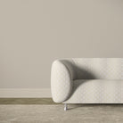 Feathered Velvet gold fire retardant upholstery fabric displayed on a sofa