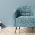 Feathercrest Azure fire retardant velvet fabric shown upholstered on a chair with blue fan design