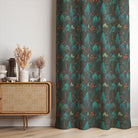 Folk garden cotton curtain fabric with woodland floral print in green and red, styled as floor-length curtains.