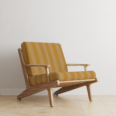  Foxwolde Striped Upholstery Fabric in Ochre – bold ochre stripe fabric used on accent chair