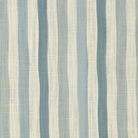Flat lay image of Fremont Mist striped curtain fabric in pale blue, ivory, and linen tones.