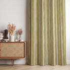 Fresno Stripe Golden linen curtain fabric styled as curtains featuring warm ochre yellow stripes in a natural-toned room