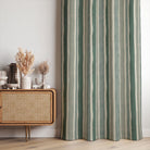 Fresno Stripe Green linen curtain fabric made into curtains with tonal sage green and ivory stripes in a calm, neutral living space