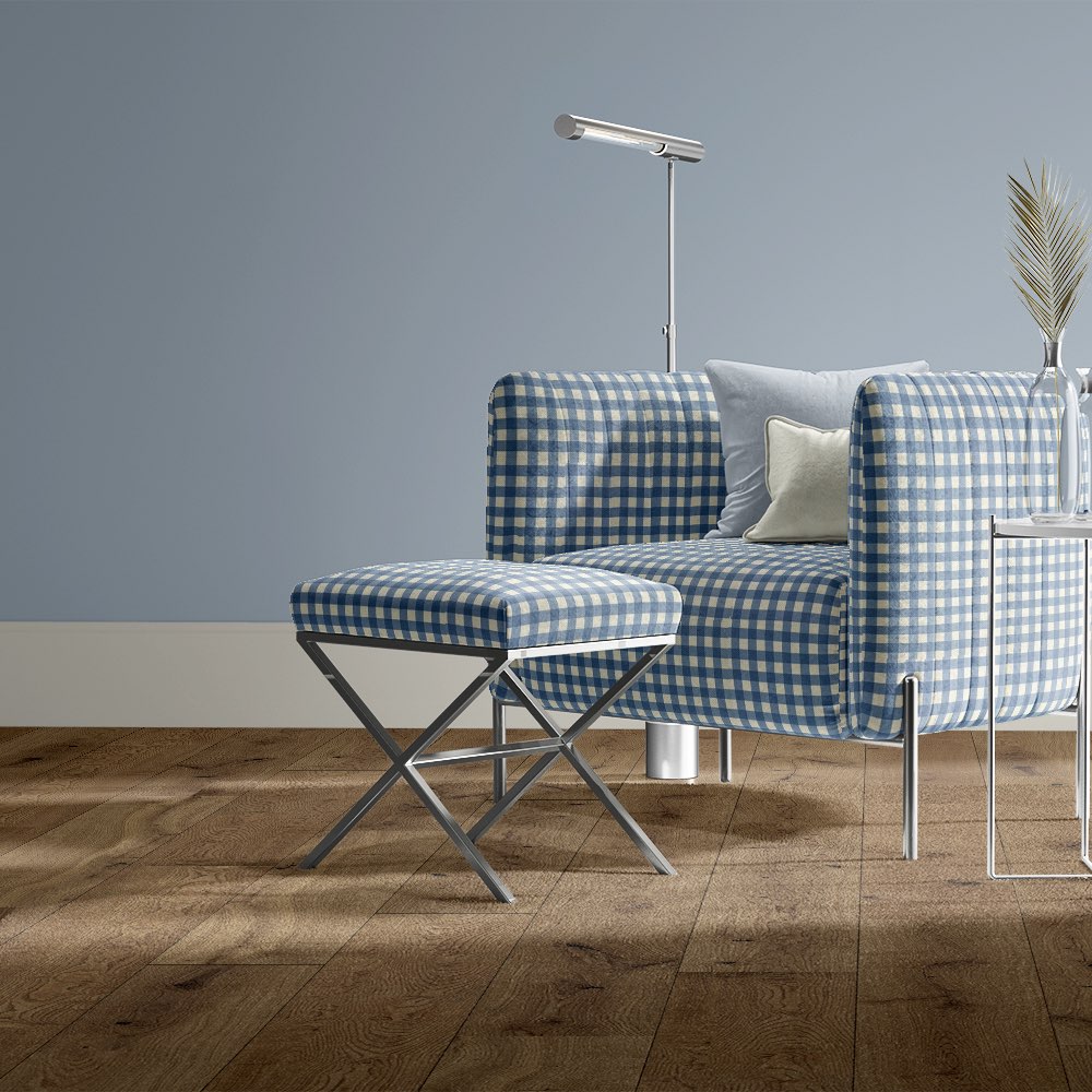 Blue gingham check upholstery fabric used on a contemporary chair and stool in a light blue room.