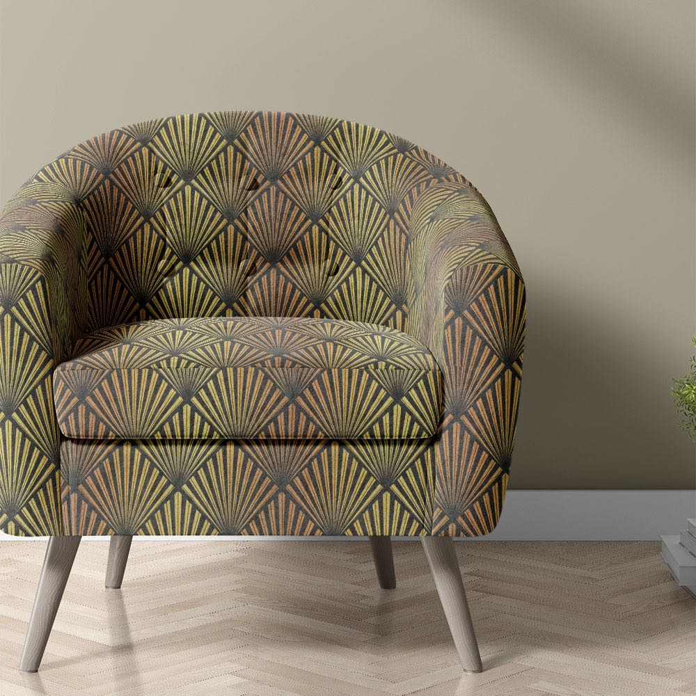     art deco upholstery fabric used on armchair with bold geometric fan pattern in black and gold