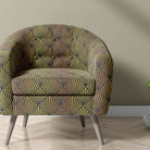     art deco upholstery fabric used on armchair with bold geometric fan pattern in black and gold