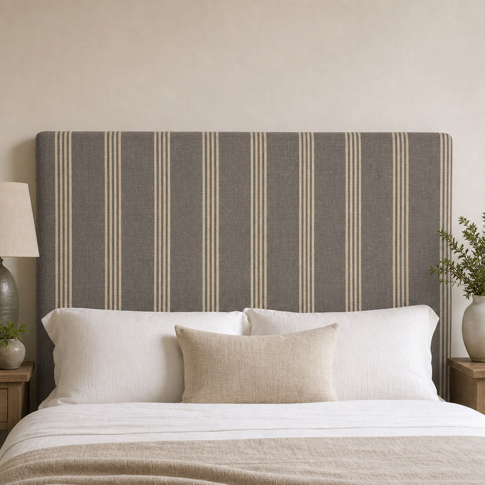 Hampton Slate striped upholstery fabric shown on a headboard, tailored striped fabric for bedroom upholstery and cushions
