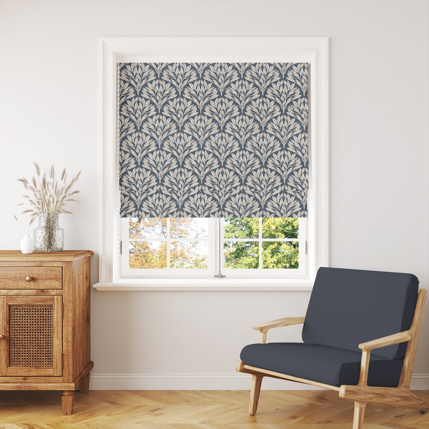 Harewood Leaf Linen curtain fabric in navy, styled as a window blind for a bold and elegant interior.
