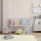     multicolour cushion display featuring hand drawn cotton curtain fabric in blush green blue and ochre tones