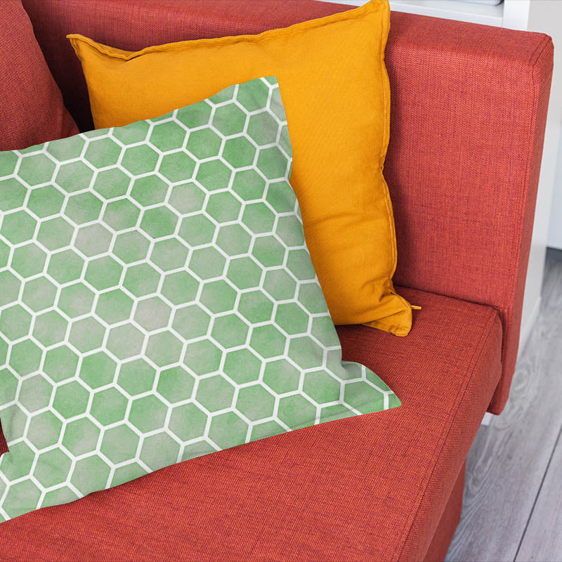 Green geometric curtain fabric shown as a patterned cushion in a contemporary interior