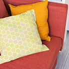Yellow honeycomb fabric cushion bringing warm geometric colour to a modern room