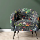 Jungle velvet upholstery fabric shown on a chair with tropical animal and leaf print