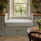 Kebir Aegean geometric upholstery fabric shown on a window bench, blue Mediterranean fabric for seating and cushions