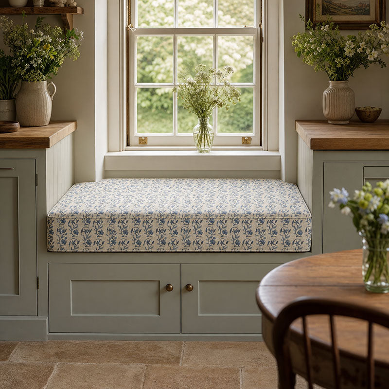 Kebir Aegean geometric upholstery fabric shown on a window bench, blue Mediterranean fabric for seating and cushions