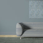Khenifra Sapphire railroaded velvet upholstery fabric shown on a sofa with horizontal stripe layout