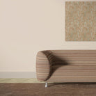 Khenifra Terracotta railroaded velvet upholstery fabric displayed on a sofa with horizontal stripe direction