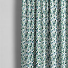 Kielder washable botanical fabric displayed as blue-green leaf print curtains in a light interior
