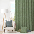 Laguna Green curtain fabric shown in a bright space with coordinating cushions