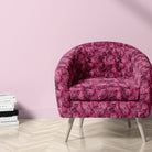 Pink leopard print velvet upholstery fabric on a statement chair in a blush interior