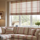 Red striped curtain and sofa fabric in a cosy living room, styled with a corner window and matching blinds