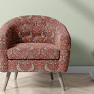 arts and crafts upholstery fabric with bird and floral pattern used on armchair in red william morris style design