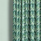 Mercia botanical fabric styled as rich green leaf curtains for a nature-inspired living space