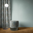 Peacock Velvet Fabric in Mineral – draped curtain showcasing bold peacock pattern on blue velvet